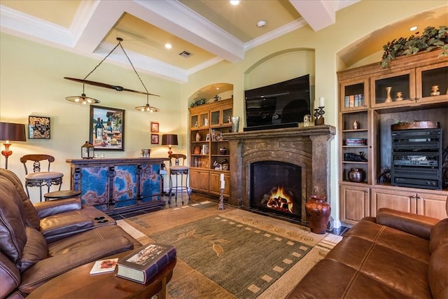 living room with crown molding, built in shelves, a high end fireplace, and beamed ceiling