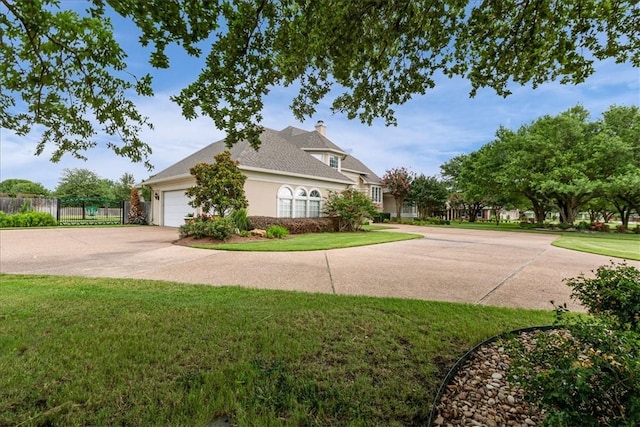 view of side of home with a garage and a lawn