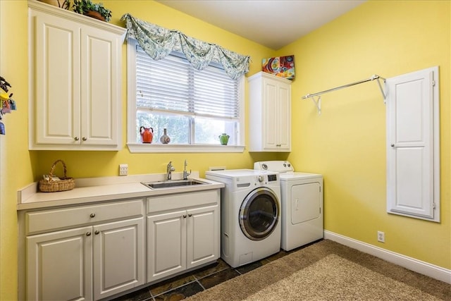 laundry room featuring cabinets, washing machine and dryer, and sink