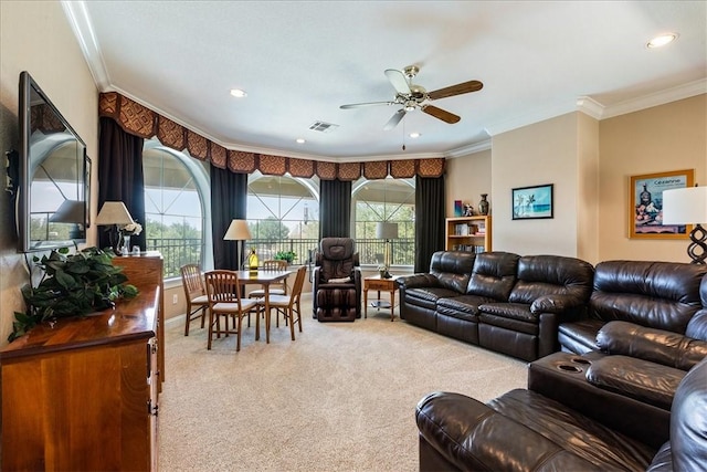 living room with ceiling fan, ornamental molding, and carpet floors