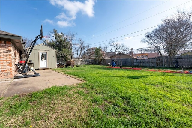 view of yard featuring a storage shed and a patio area