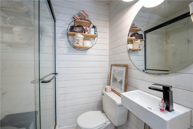 bathroom featuring a shower with shower door, wood walls, and toilet