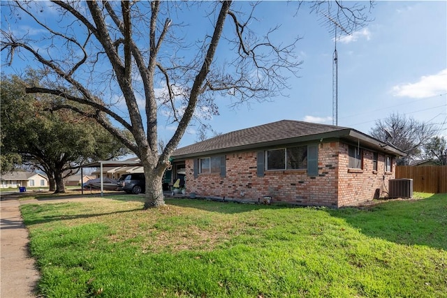 view of home's exterior with a carport, a yard, and central air condition unit