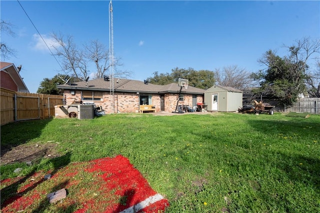 back of property featuring an outdoor structure and a lawn