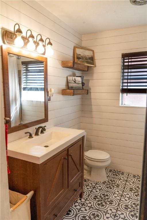 bathroom with vanity, toilet, and tile patterned flooring