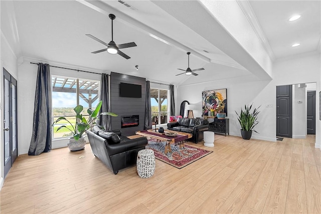 living room featuring vaulted ceiling with beams, light hardwood / wood-style floors, and plenty of natural light