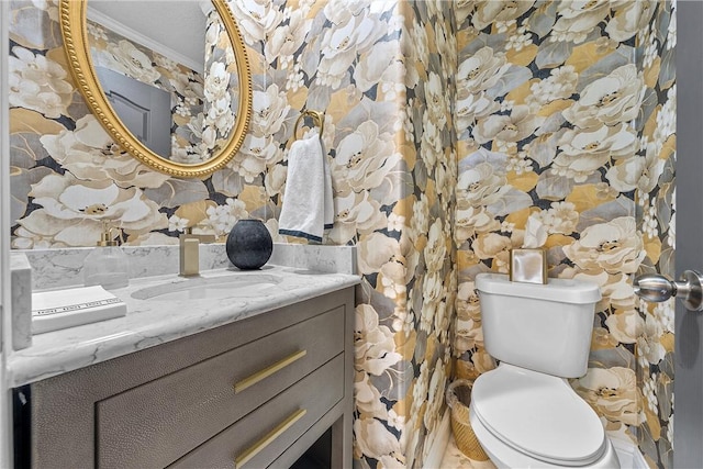 bathroom with vanity, toilet, and crown molding