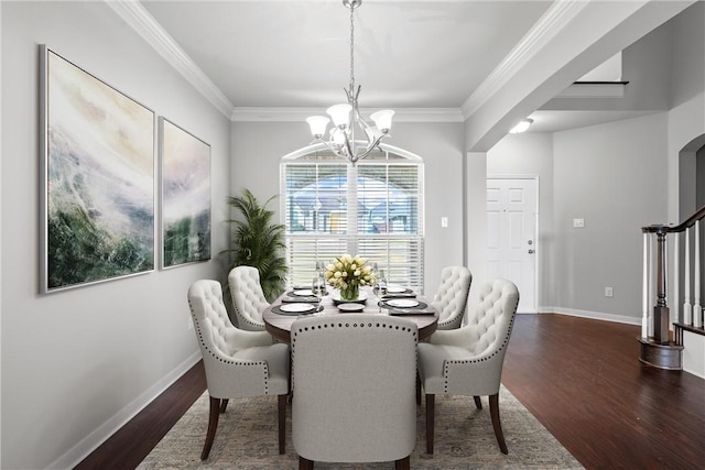 dining room with crown molding, dark wood-type flooring, and a chandelier