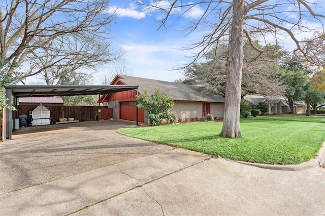 view of front of house with a front yard, a carport, and a garage