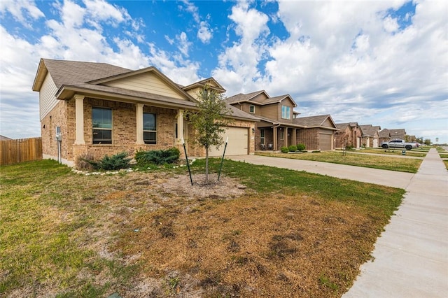 craftsman inspired home featuring a garage and a front lawn