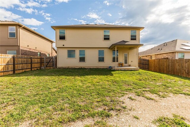 rear view of house with a yard and a patio area