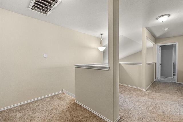 hallway featuring light colored carpet