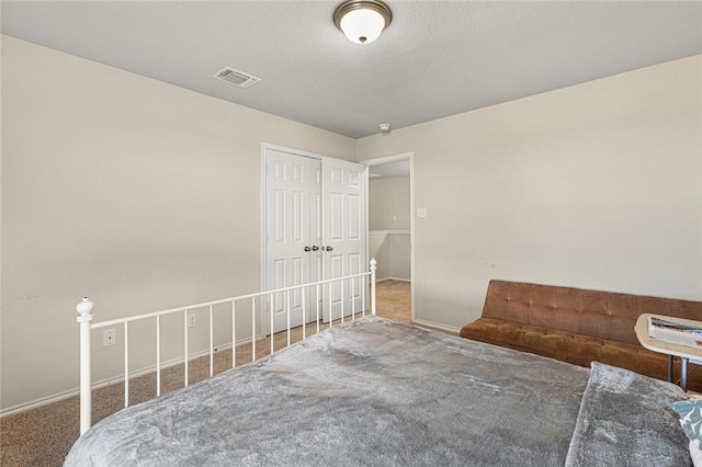 unfurnished bedroom with a closet, carpet, and a textured ceiling