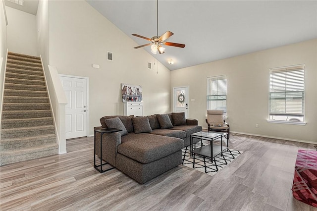 living room featuring ceiling fan, light hardwood / wood-style flooring, and high vaulted ceiling