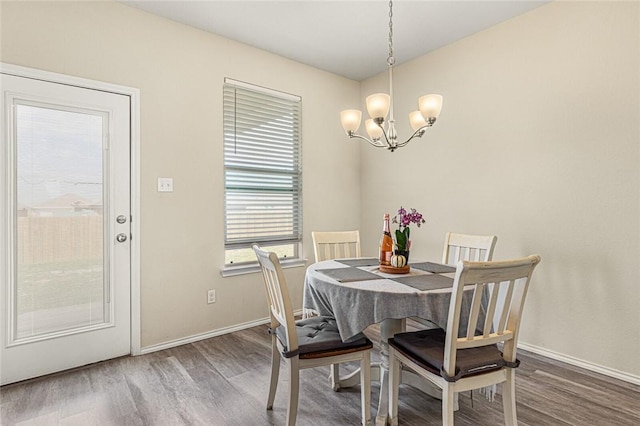 dining space with a chandelier and dark wood-type flooring