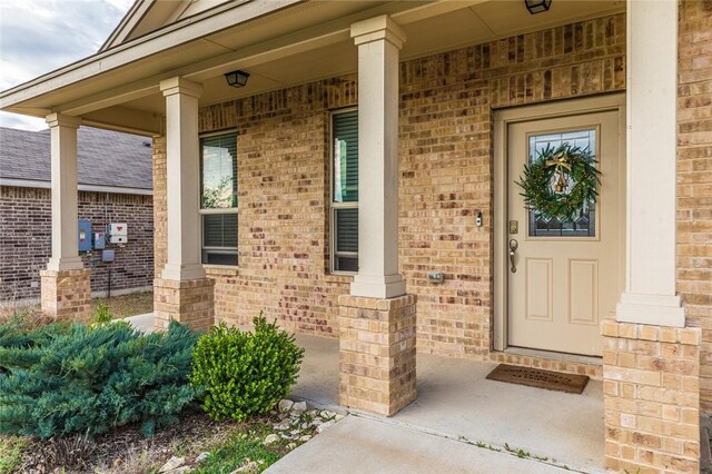 view of exterior entry featuring a porch