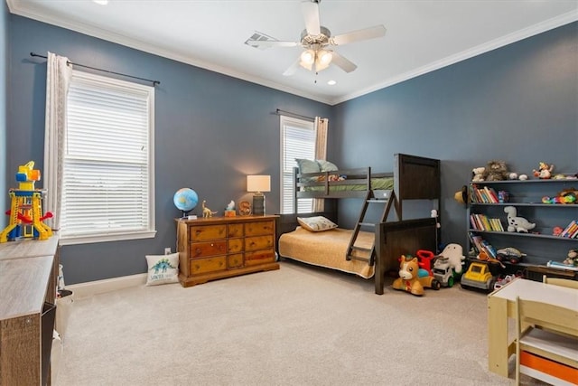 carpeted bedroom featuring baseboards, a ceiling fan, and crown molding