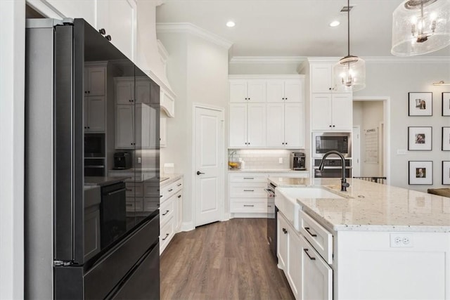 kitchen featuring white cabinets, decorative backsplash, dark wood-style floors, stainless steel microwave, and ornamental molding