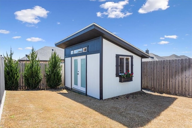 view of outdoor structure with a fenced backyard and an outdoor structure