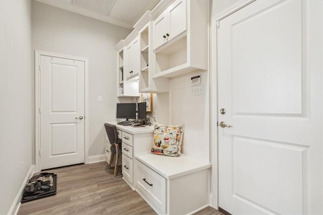 mudroom featuring light wood-style floors and baseboards