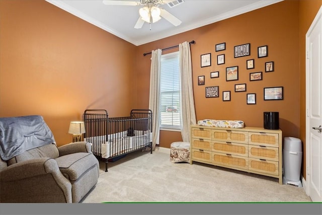 carpeted bedroom featuring ceiling fan, ornamental molding, and baseboards