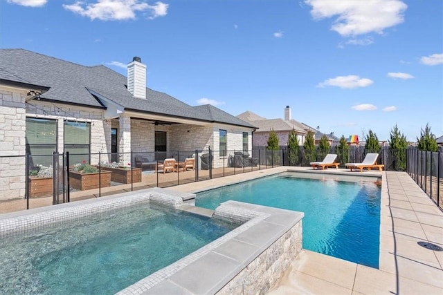 view of swimming pool with a patio area, a pool with connected hot tub, fence, and a ceiling fan