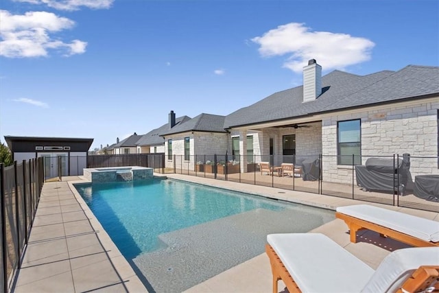 view of swimming pool with a patio area, a pool with connected hot tub, fence, and a ceiling fan