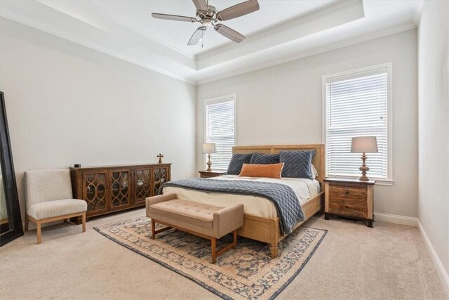 bedroom with light carpet, ornamental molding, a raised ceiling, and baseboards