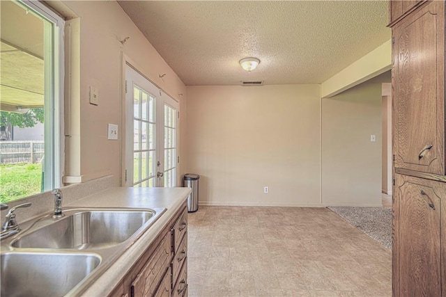 kitchen with a textured ceiling and sink