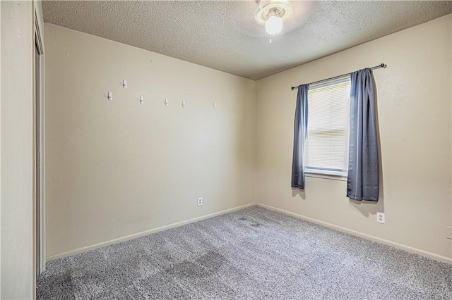 carpeted spare room featuring a textured ceiling