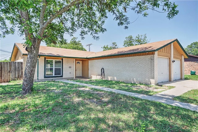 ranch-style home featuring a front yard and a garage