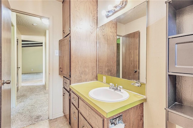 bathroom featuring tile patterned floors, vanity, and a textured ceiling