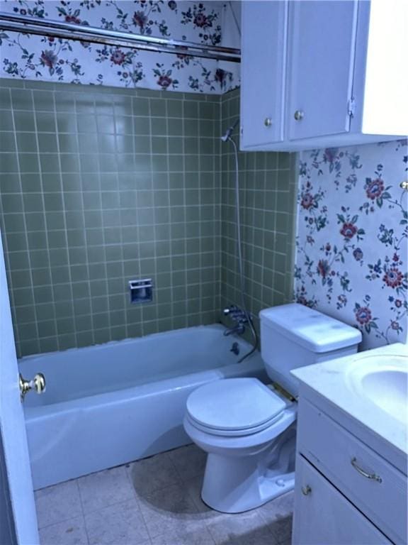 full bathroom with tile patterned flooring, vanity, toilet, and tiled shower / bath