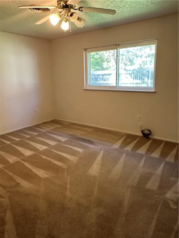 carpeted spare room featuring a textured ceiling