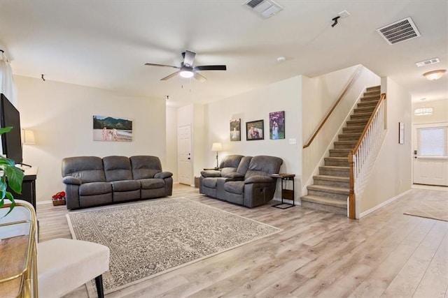 living room with ceiling fan and light hardwood / wood-style floors