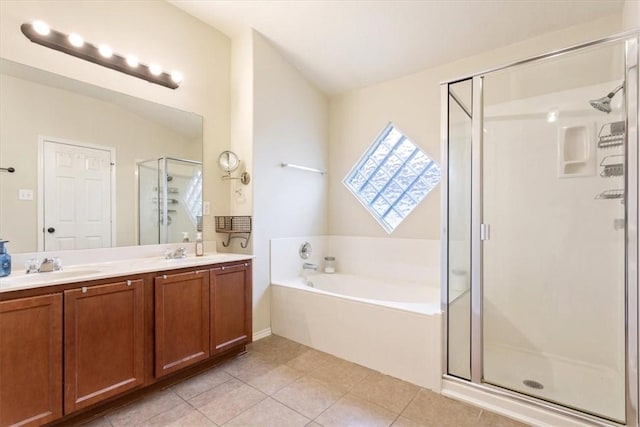 bathroom featuring tile patterned flooring, vanity, and shower with separate bathtub