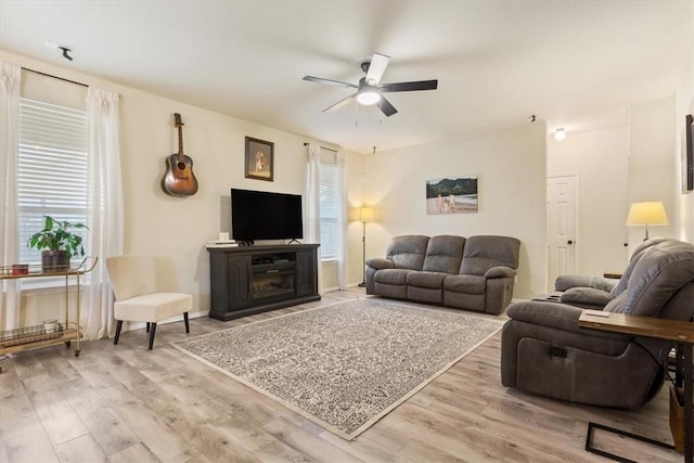 living room featuring ceiling fan and light wood-type flooring