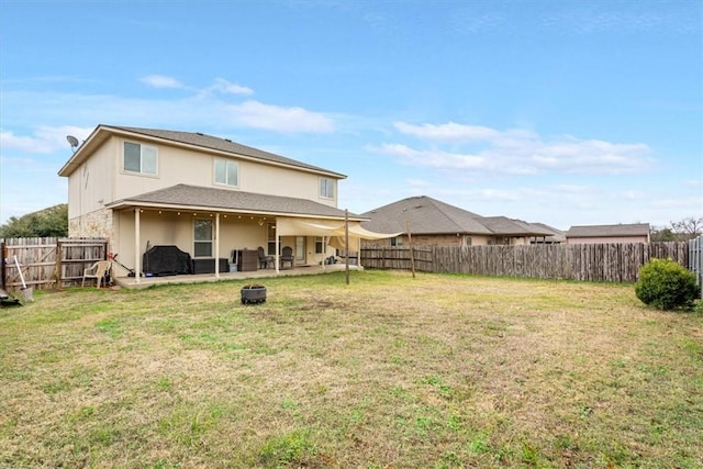 back of property with a patio and a lawn