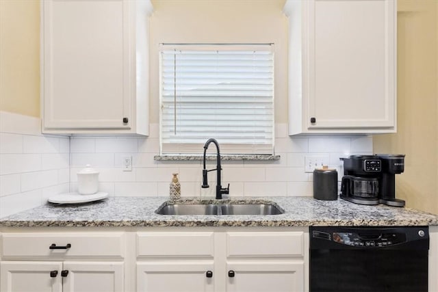 kitchen featuring white cabinets, dishwasher, light stone counters, and sink