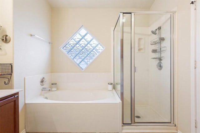 bathroom featuring plus walk in shower and vanity