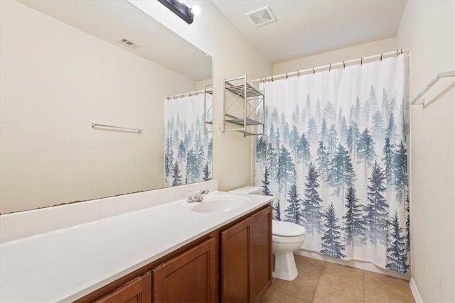 bathroom with tile patterned flooring, a shower with curtain, vanity, and toilet