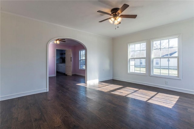 unfurnished room with dark hardwood / wood-style flooring, ceiling fan, and crown molding