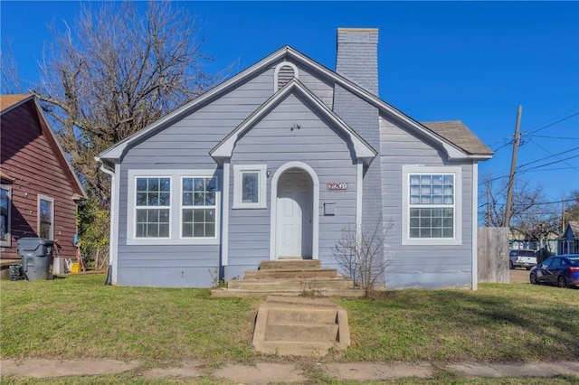 bungalow-style house with a front yard