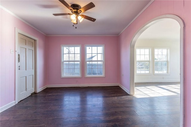 unfurnished room featuring ceiling fan, dark hardwood / wood-style flooring, ornamental molding, and plenty of natural light