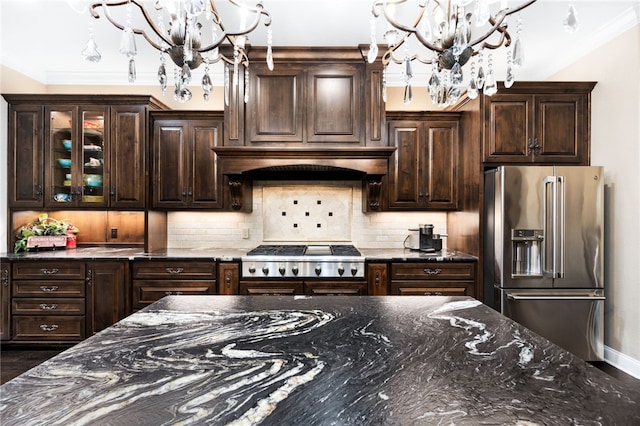 kitchen featuring dark brown cabinets, stainless steel appliances, and a notable chandelier