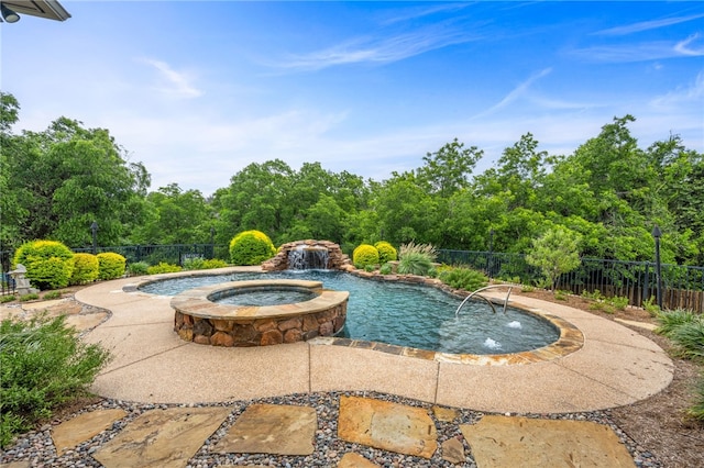 view of pool featuring pool water feature and an in ground hot tub