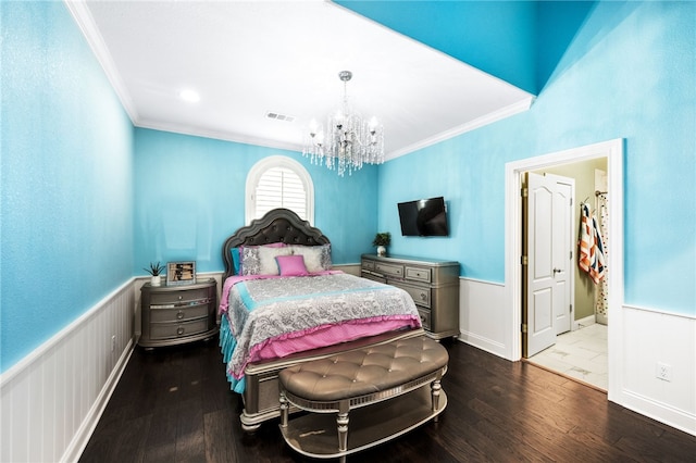 bedroom featuring wood-type flooring, crown molding, and a notable chandelier