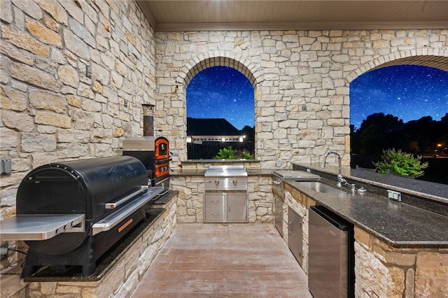 view of patio with grilling area, sink, and exterior kitchen