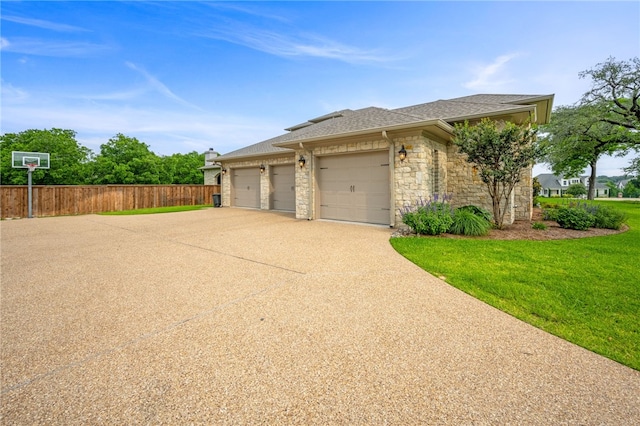 view of side of home featuring a yard and a garage