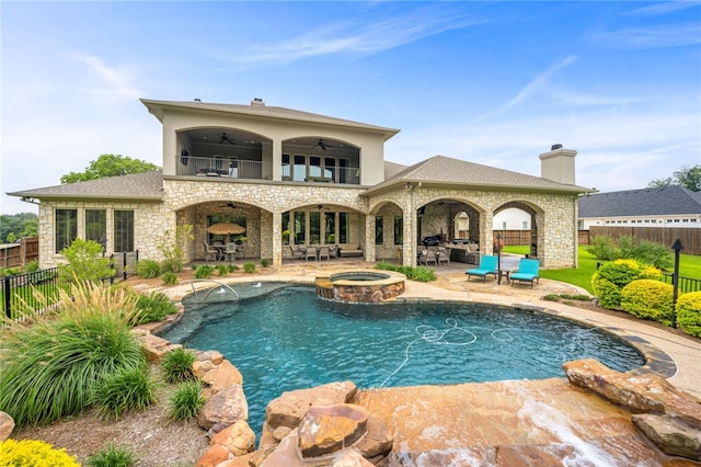 back of house with a patio area, ceiling fan, and a pool with hot tub